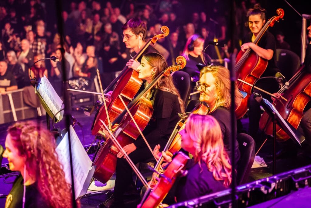 Members of the Radio Ga Ga Concert Orchestra and Bohemian Rhapsody Choir during a live QUEEN Orchestral performance.